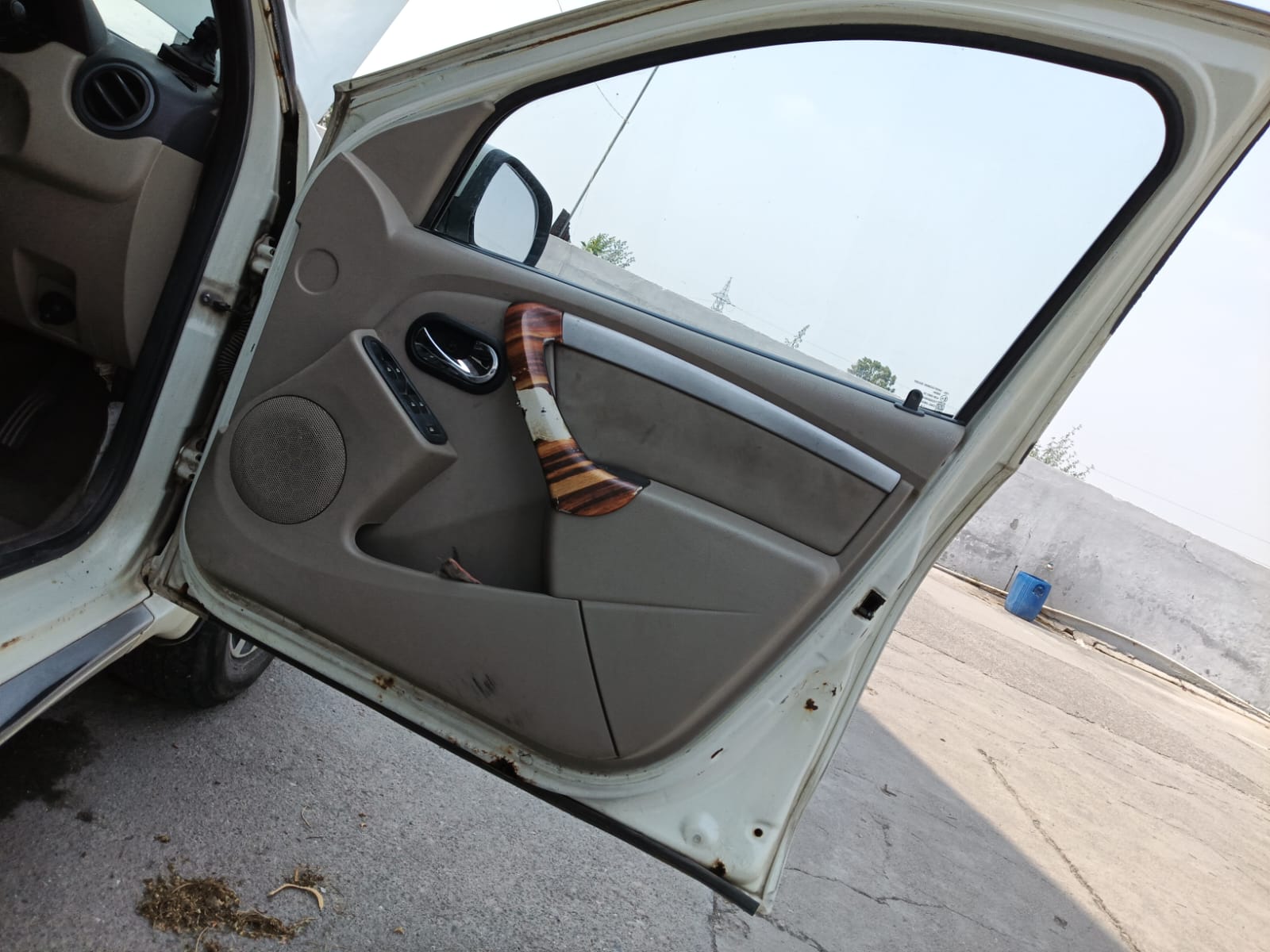 Open front door interior trim with visible wear and rust spots