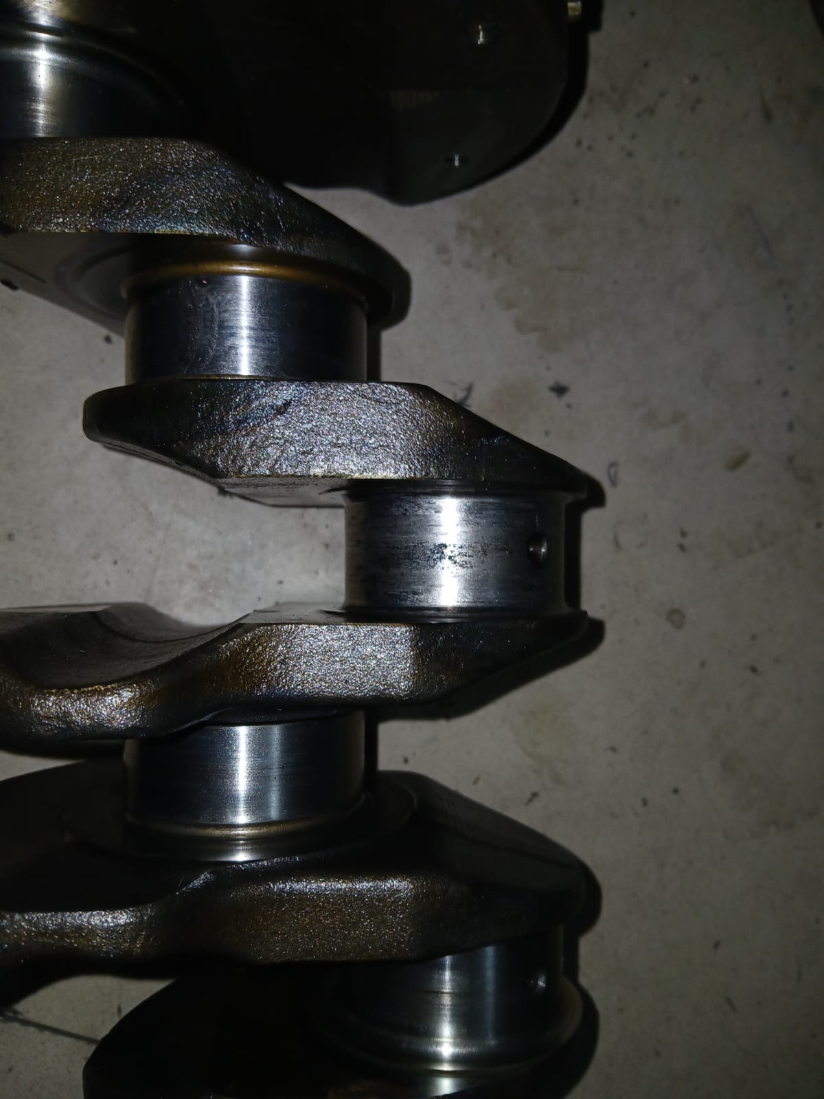 Close view of engine crankshaft journals during parts inspection