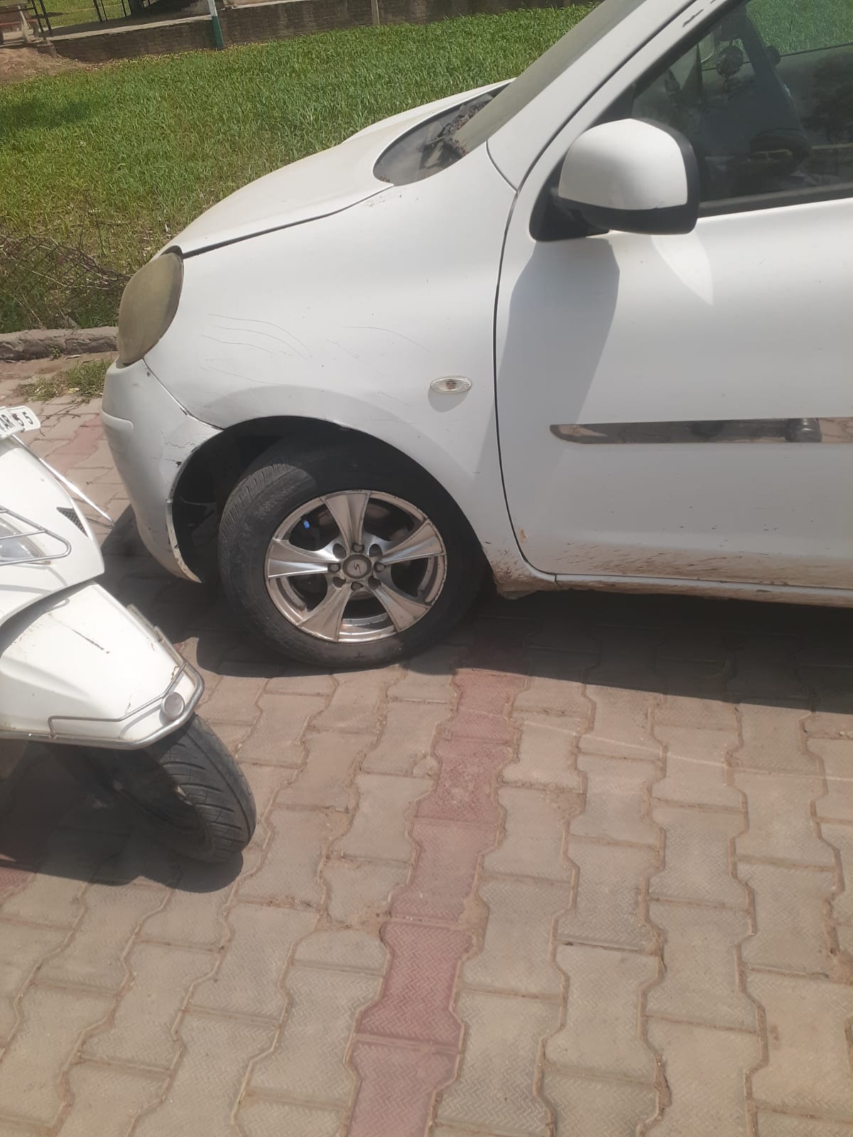 White car front fender and door area with scuffs and dirt marks