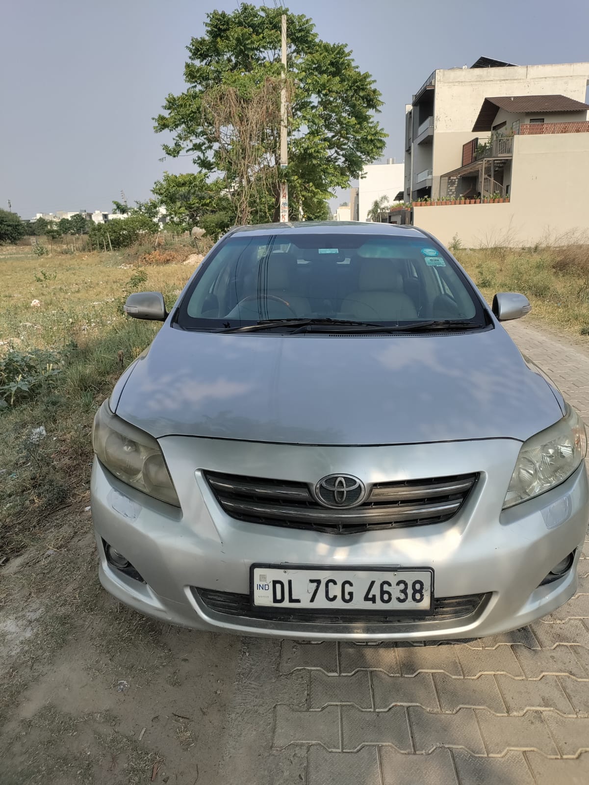 Silver Toyota Corolla front inspection photo in open yard area