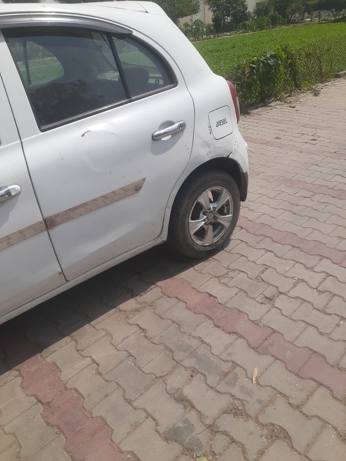 Rear door, wheel arch, and quarter panel condition on white diesel car